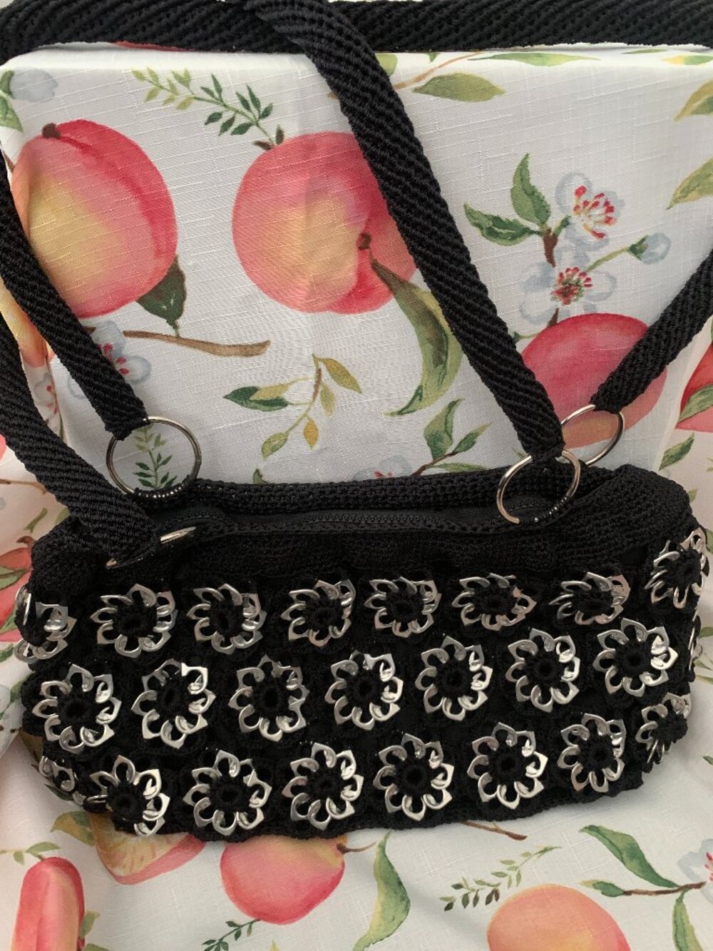Black Artisan Handbag with black shoulder straps and silver-color floral accents